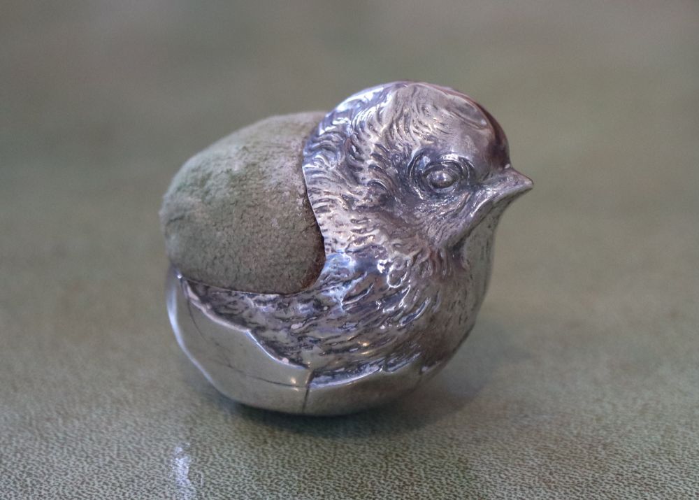 An Edwardian novelty silver mounted pin cushion modelled as a hatching chick, Sampson Mordan & Co